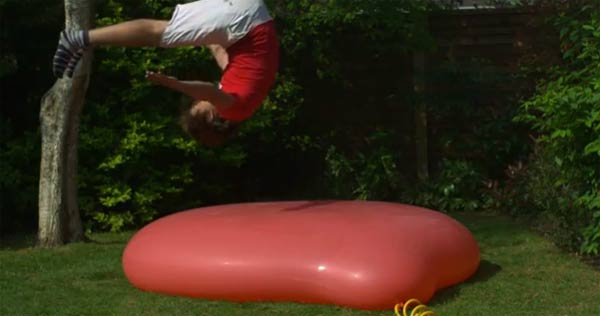 Slowmotionsprung auf gigantischen Wasserballon